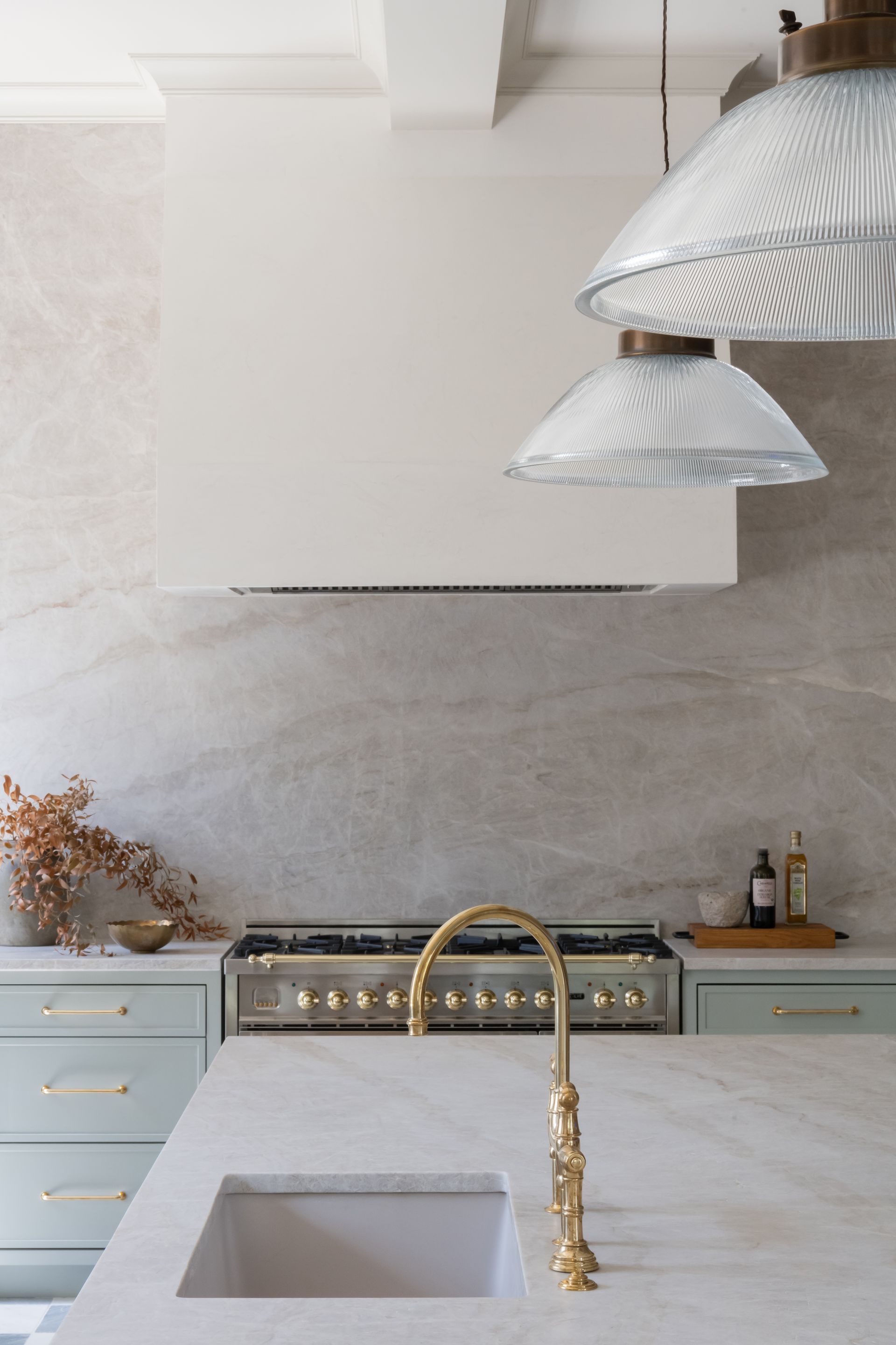 Luxury European inspired kitchen designed by nashville interior designer featuring taj mahal quartzite and white oak cabinets