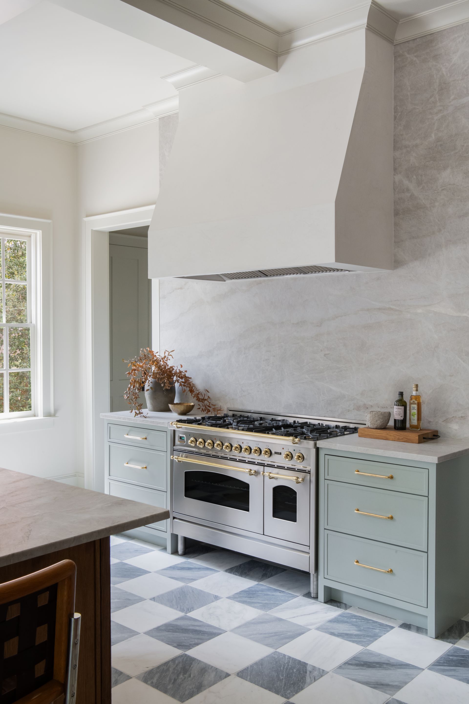 Luxury European inspired kitchen designed by nashville interior designer featuring taj mahal quartzite and white oak cabinets