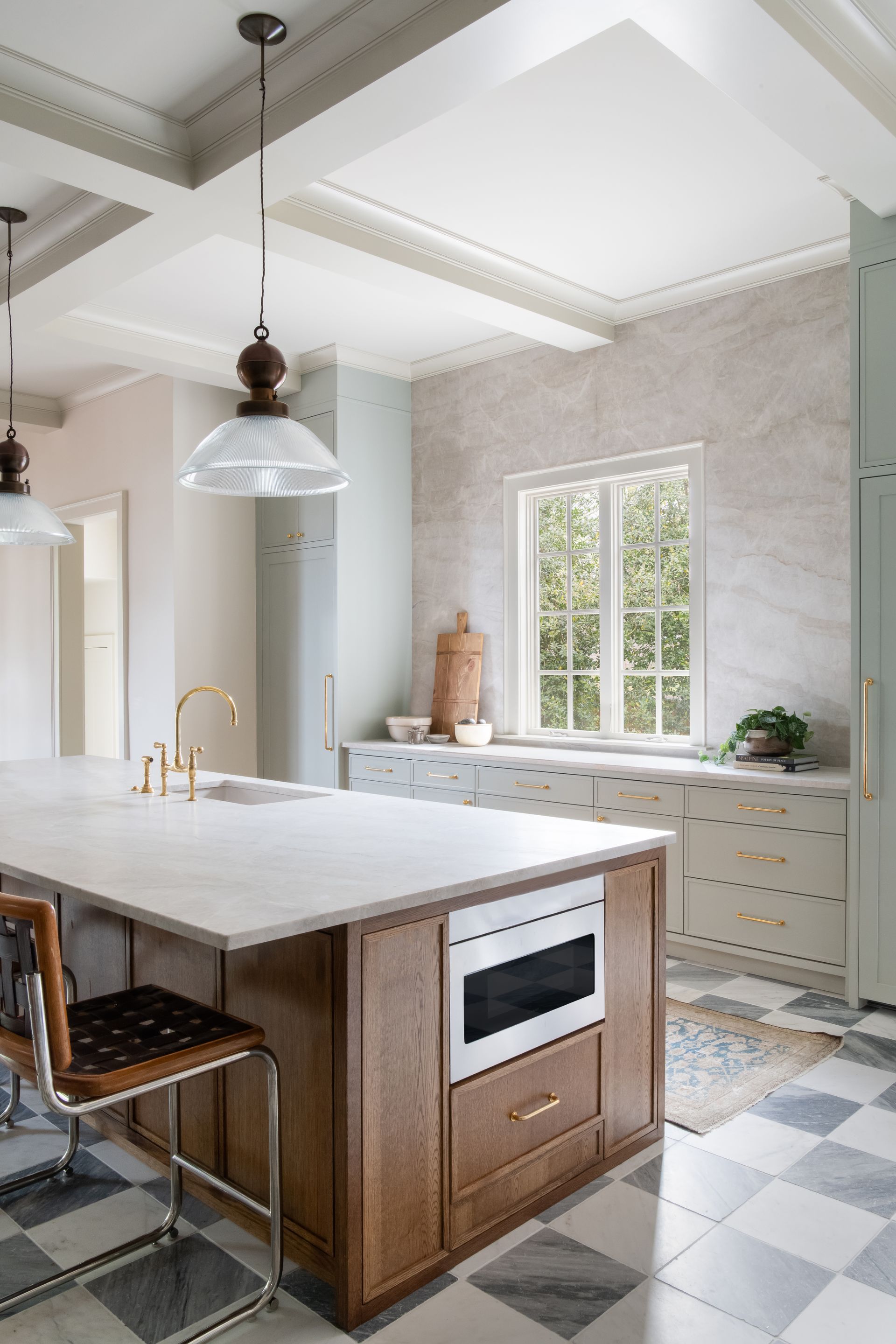 Luxury European inspired kitchen designed by nashville interior designer featuring taj mahal quartzite and white oak cabinets