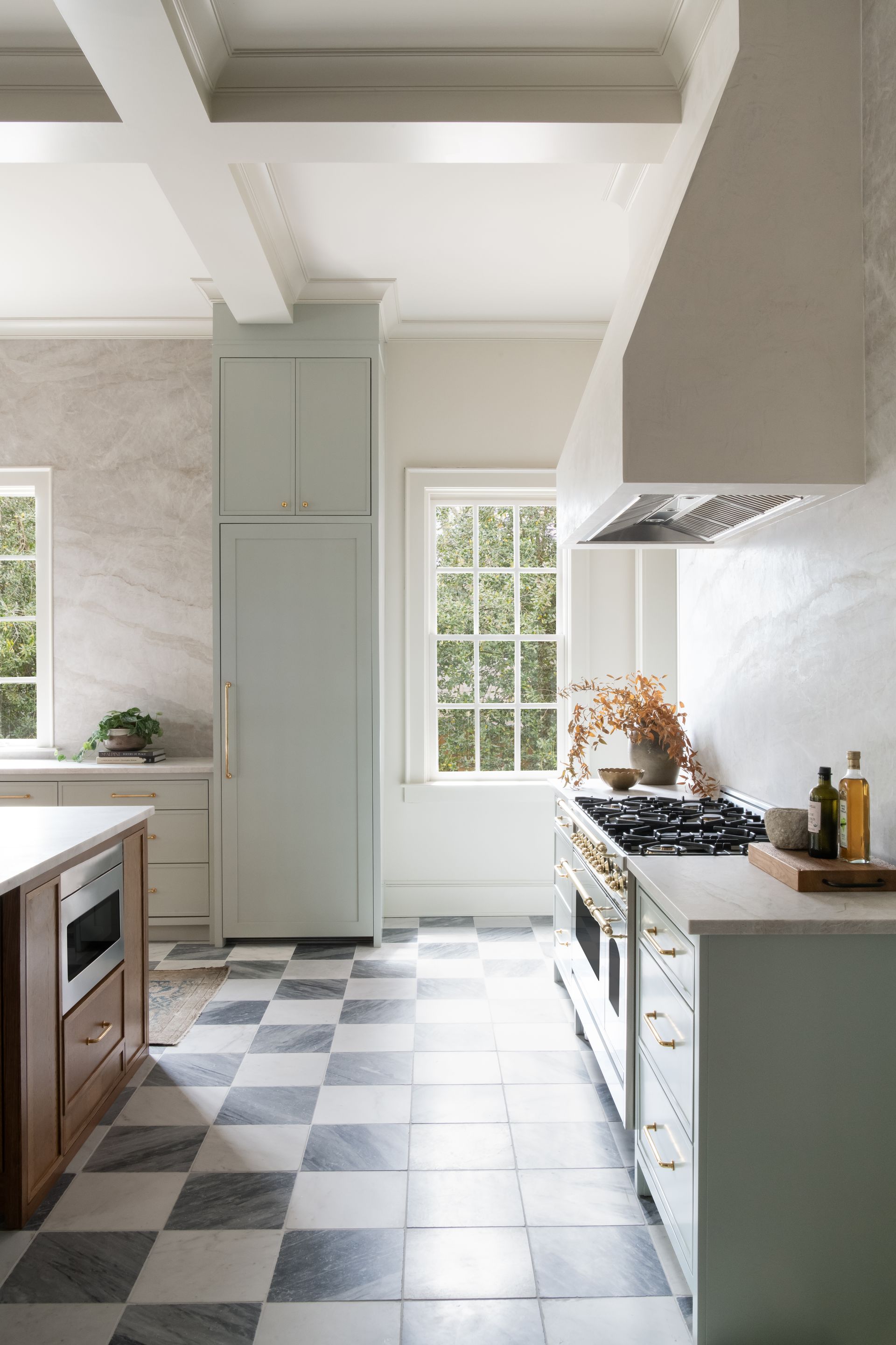 Luxury European inspired kitchen designed by nashville interior designer featuring taj mahal quartzite and white oak cabinets