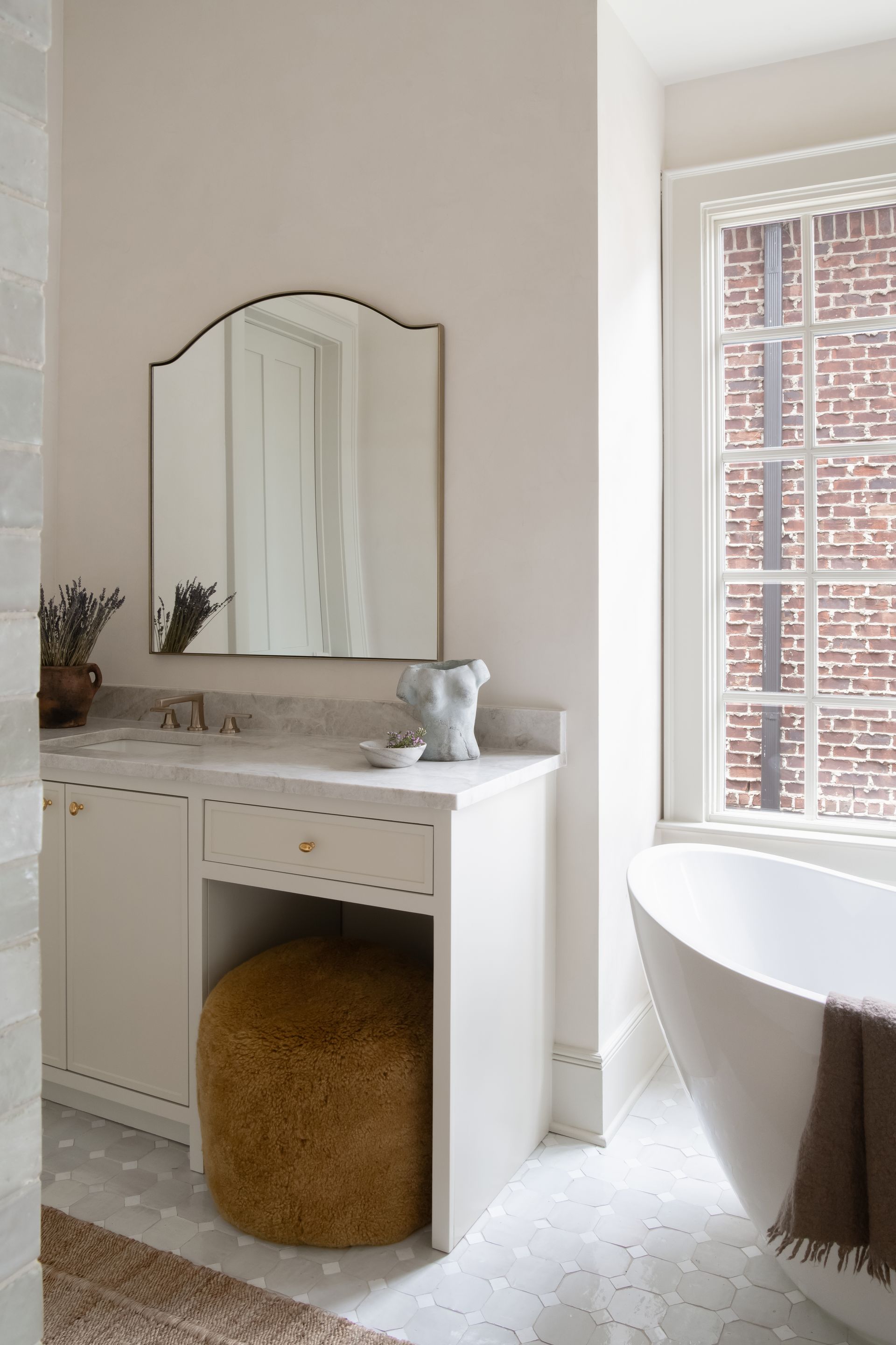 Luxury European inspired bathroom designed by nashville interior designer featuring taj mahal quartzite and zellige tile