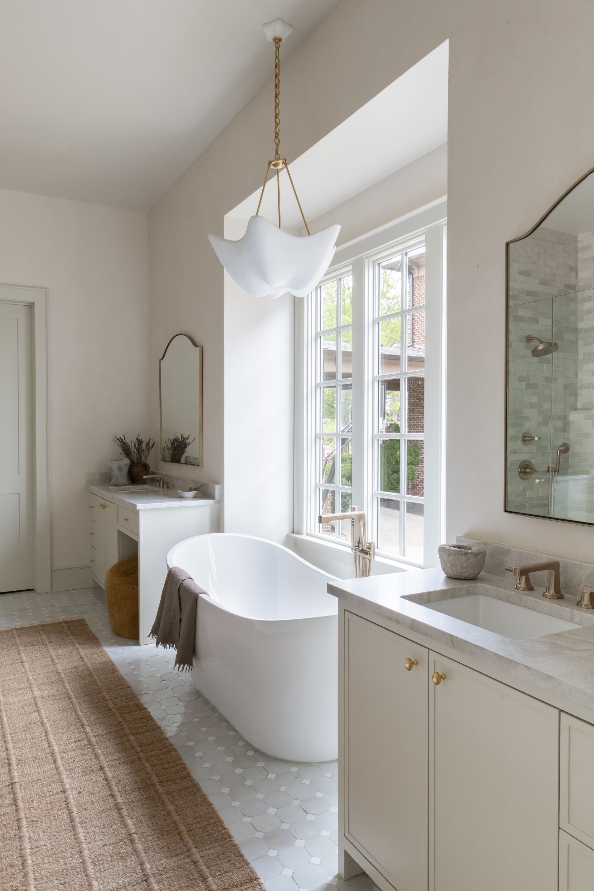 Luxury European inspired bathroom designed by nashville interior designer featuring taj mahal quartzite and zellige tile