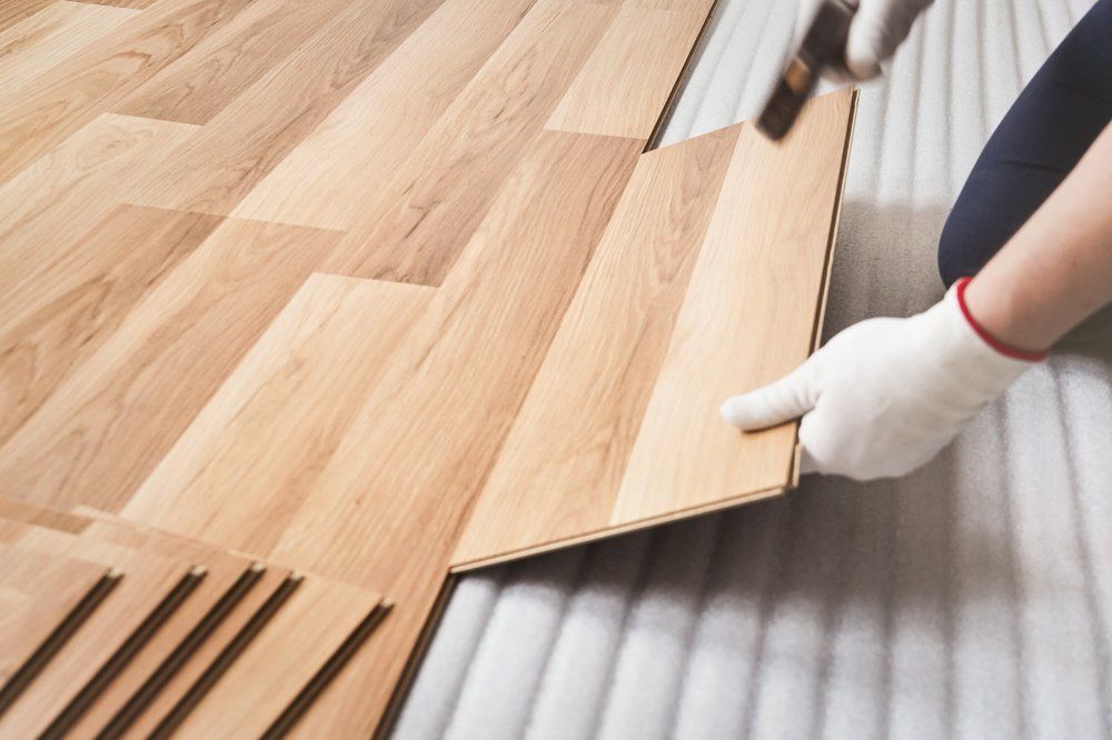 Man Hand in White Glove Holding Wooden Tile — Rochester, MN — Advance Hardware Floor Inc