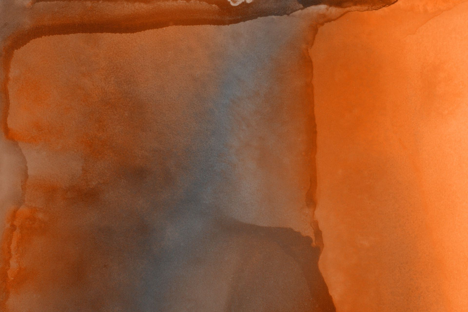 Abstract watercolor painting in orange and blue-gray hues with blending effects.