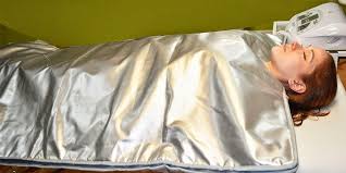 Client in silver blanket like sauna wrap