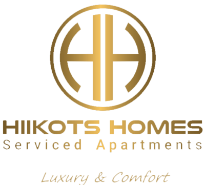 Hiikots Homes Serviced Apartments logo in gold with &ldquo;Luxury & Comfort&rdquo; tagline