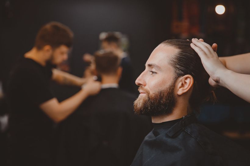 Process of cutting hair with scissors, hairdresser for men.
