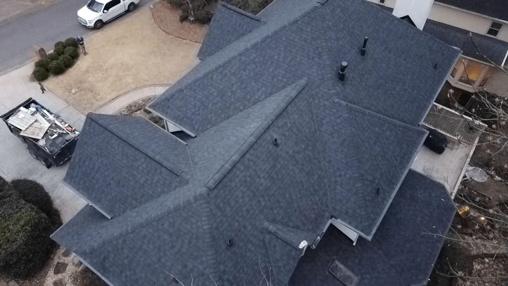 An aerial view of a large house with a gray roof.