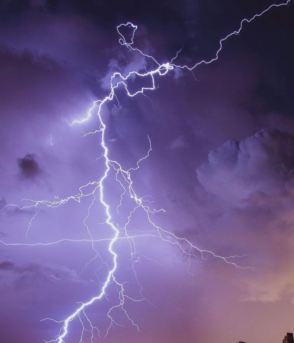 A lightning bolt is visible in the night sky