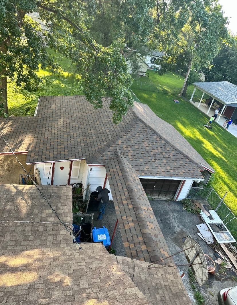 An aerial view of a house with a roof and a garage.
