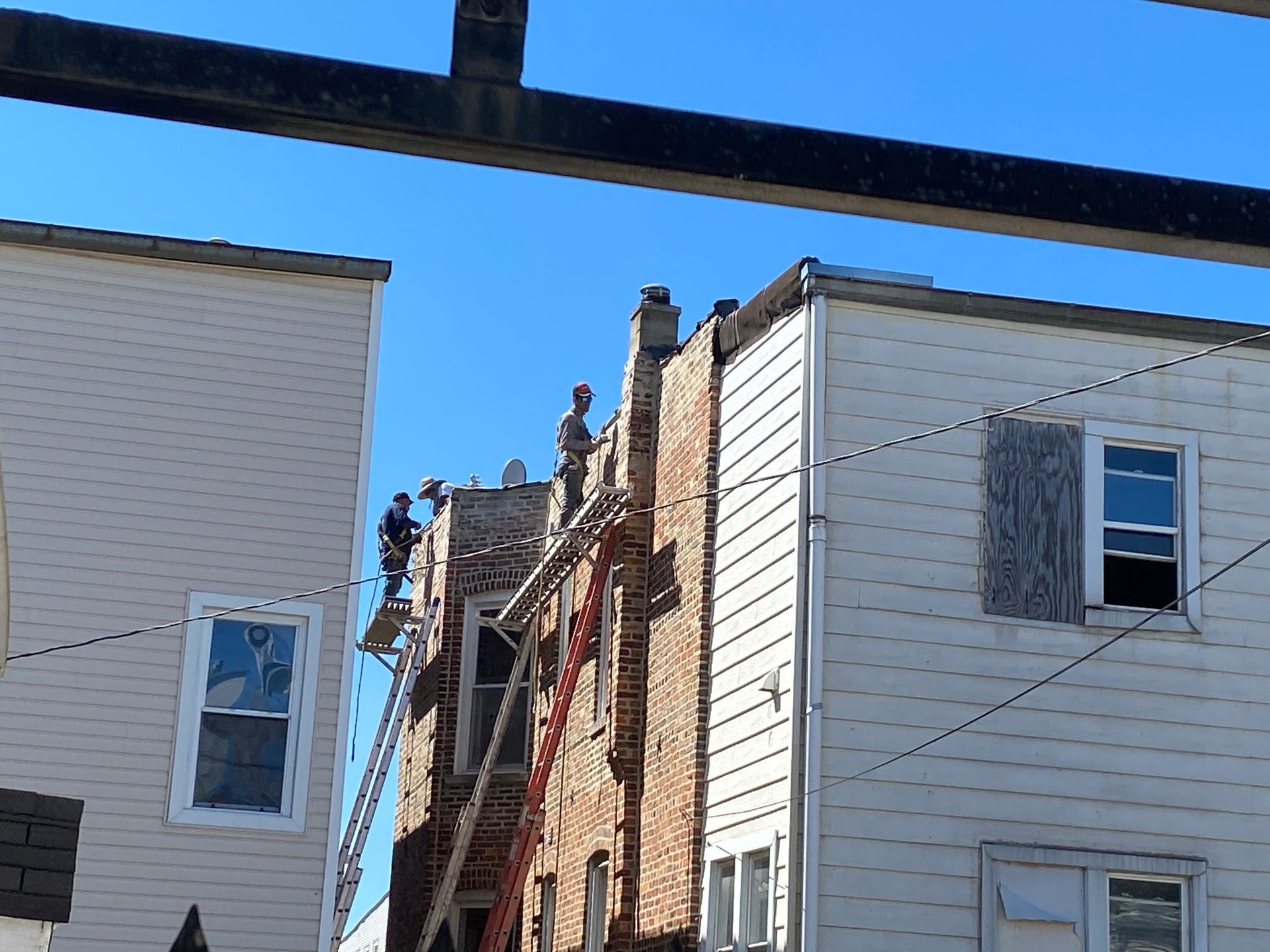 A group of people are working on the roof of a building