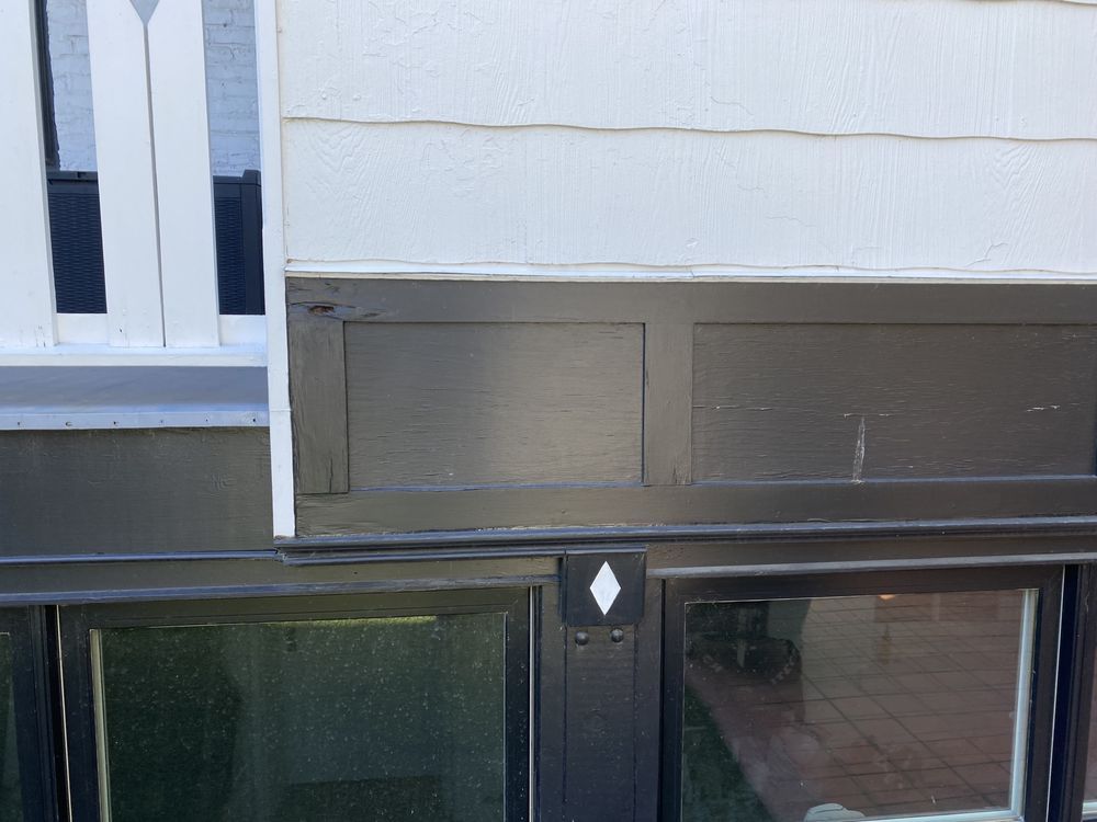 A black door with a white diamond on it