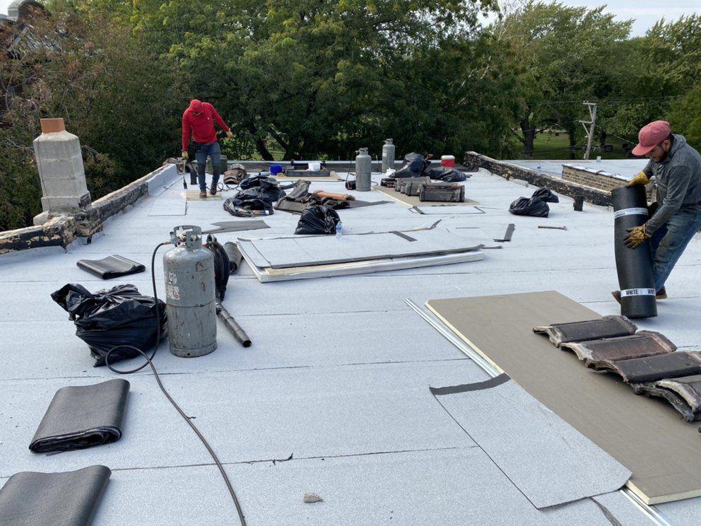 A man is working on the roof of a building.