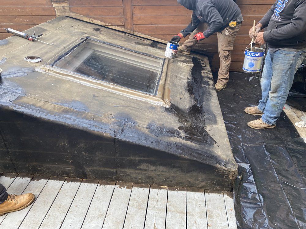 A group of men are working on a roof.