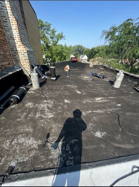 A man is standing on the roof of a building