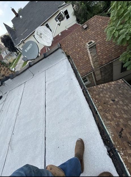 A person standing on a roof with a satellite dish on it