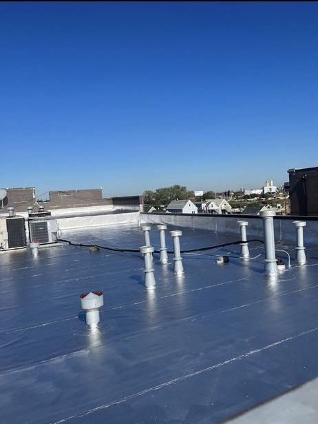 A silver roof with a blue sky in the background
