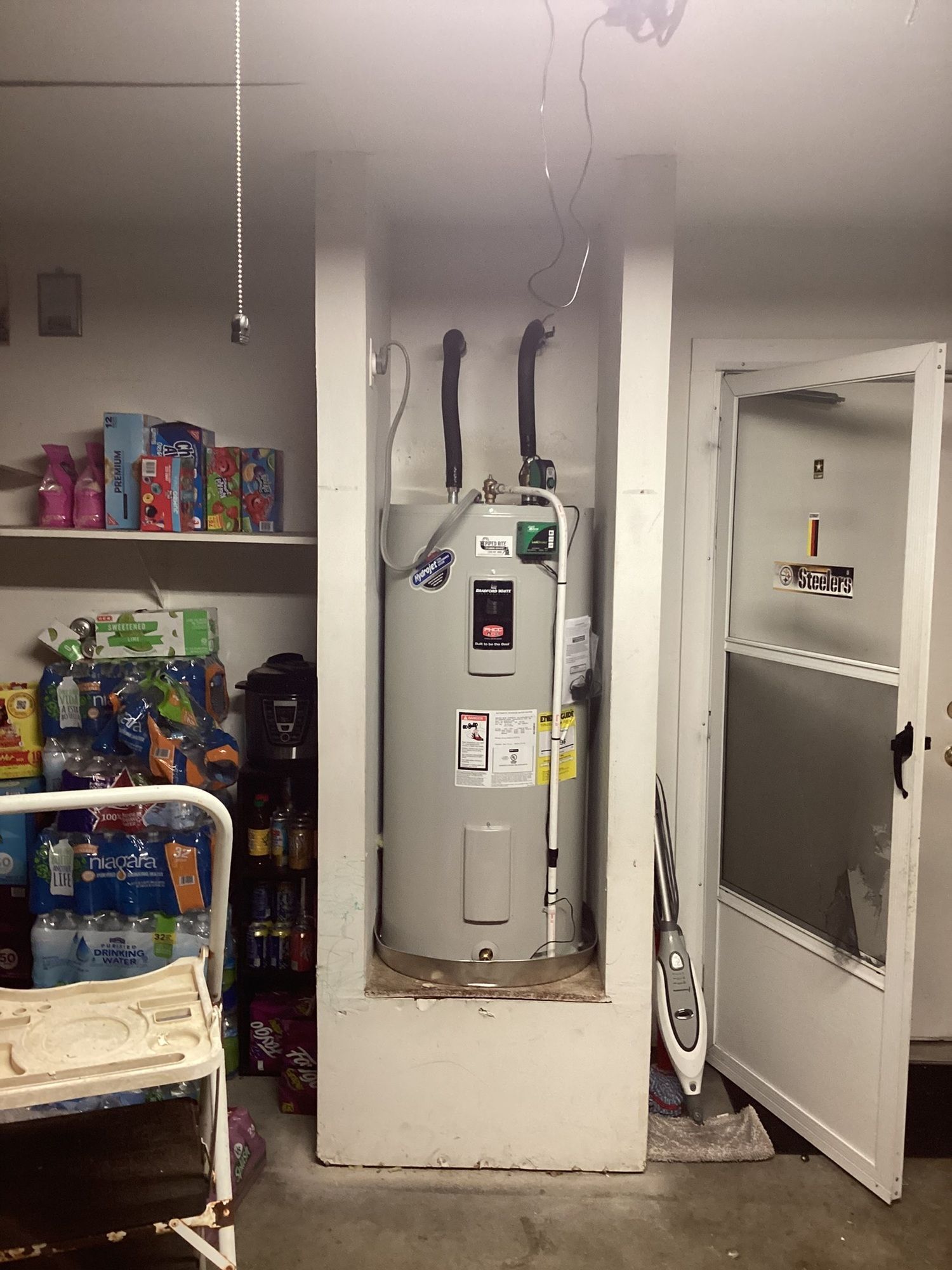 A room with a water heater in the corner
