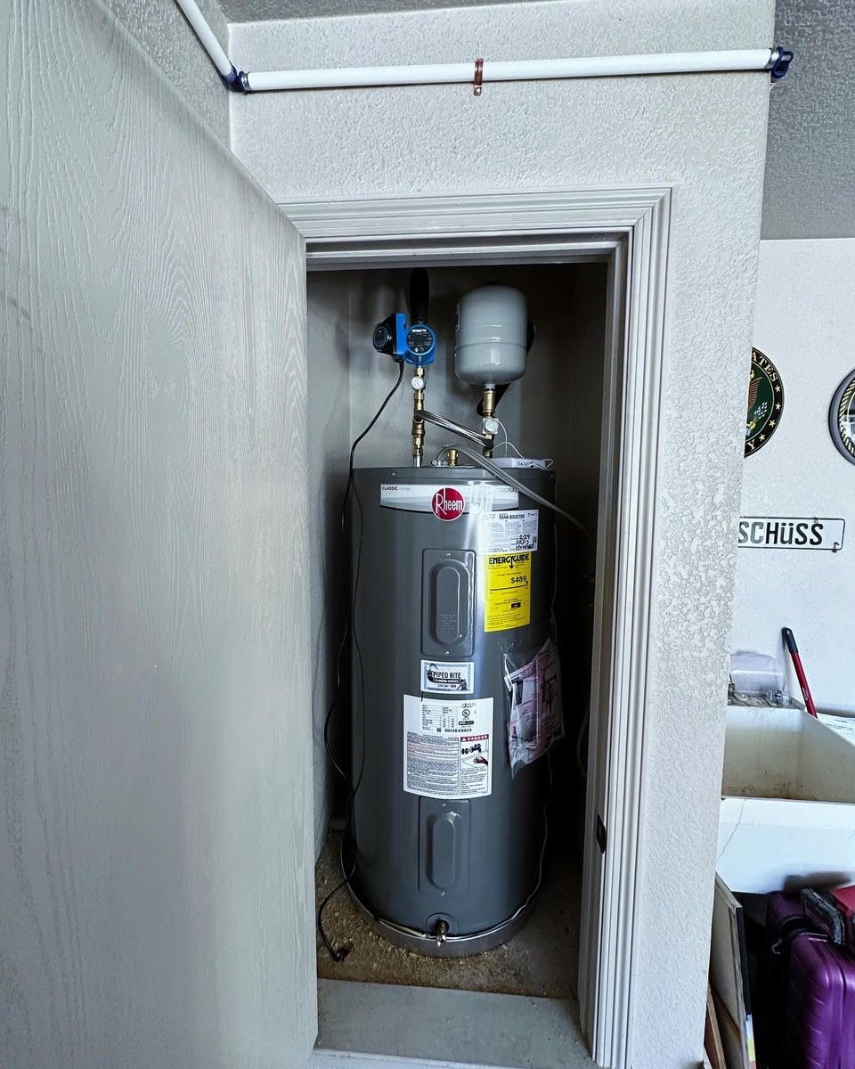A water heater in a closet with a sign that says schmier