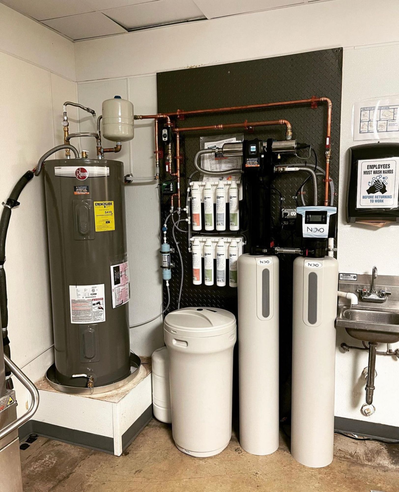A room with a water heater and a sink