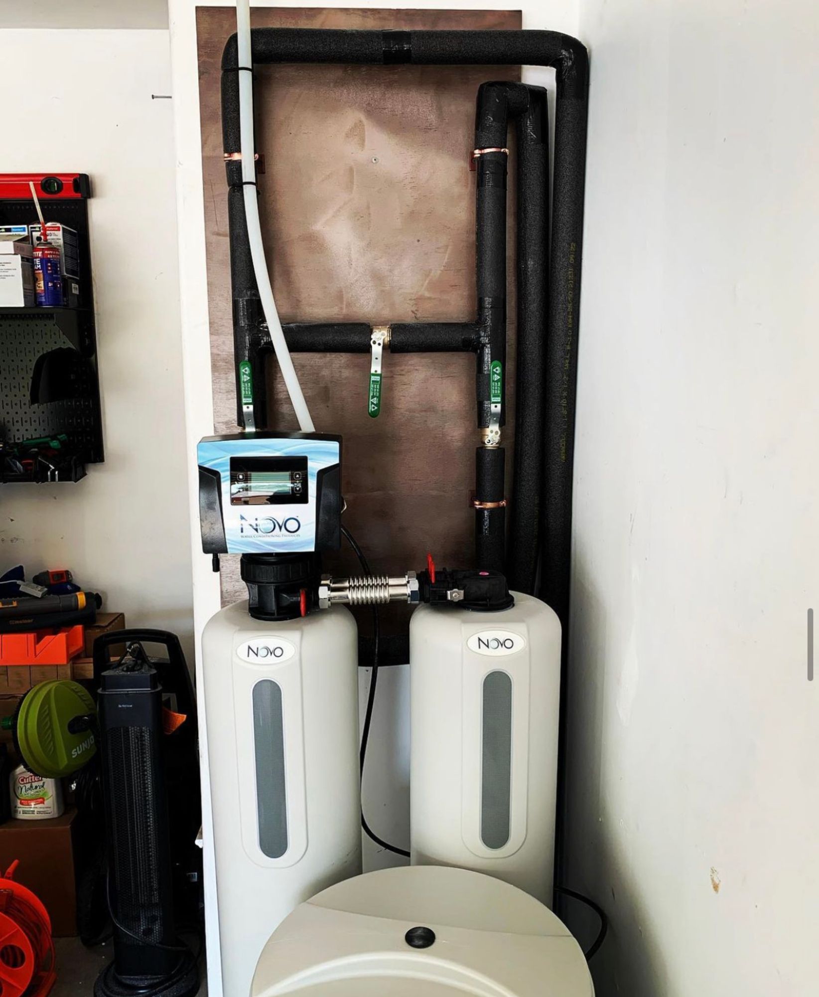 A bathroom with a toilet and a water filter that says n30 on it