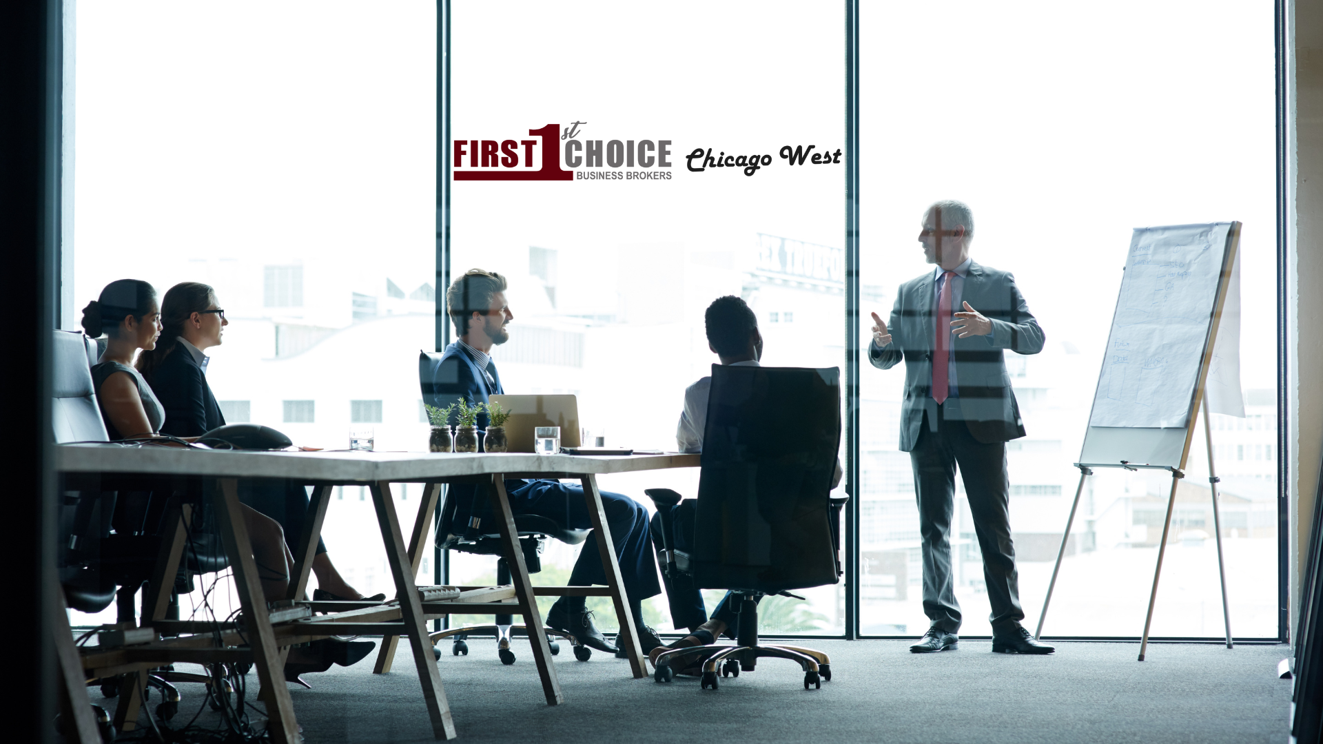 A man is giving a presentation to a group of people in a conference room.