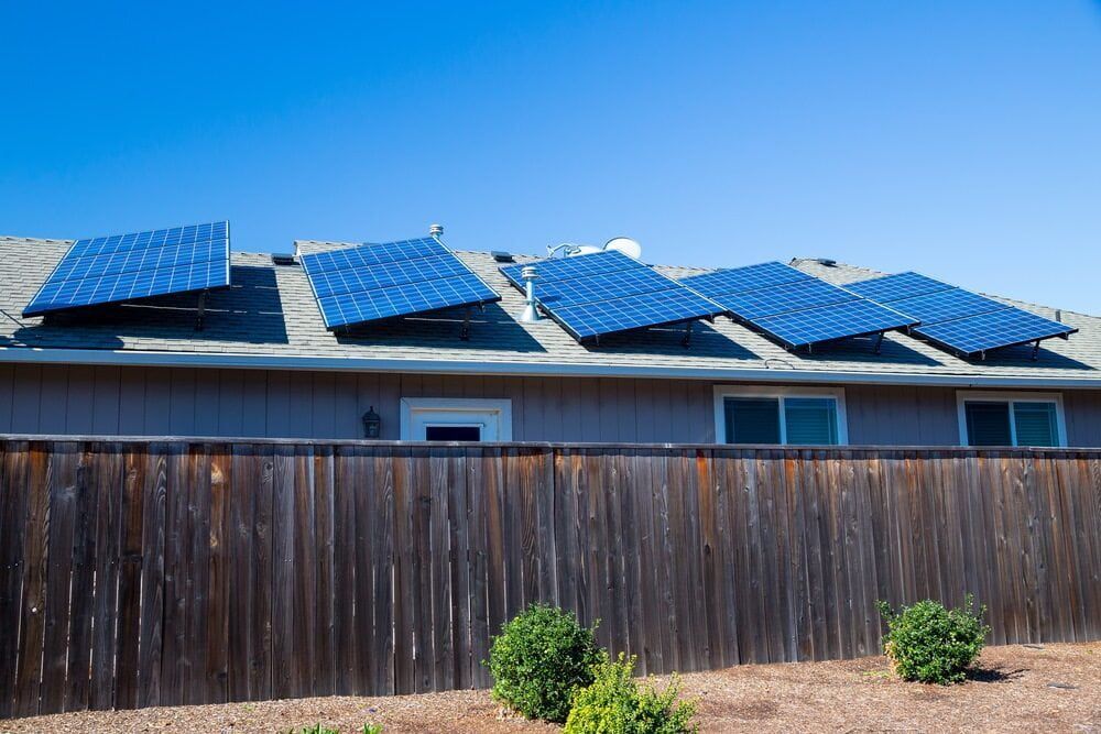 A House With Solar Panels on the Roof and a Wooden Fence — 888 Solar Tek in Kyogle, NSW