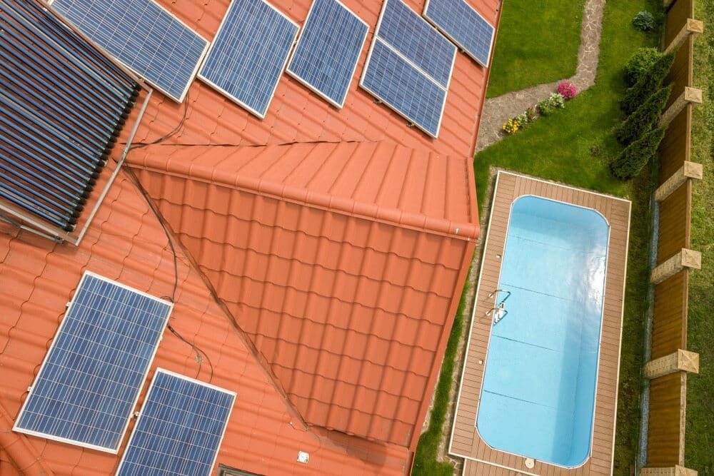 An Aerial View of a House With Solar Panels on the Roof and a Swimming Pool — 888 Solar Tek in Byron Bay, NSW