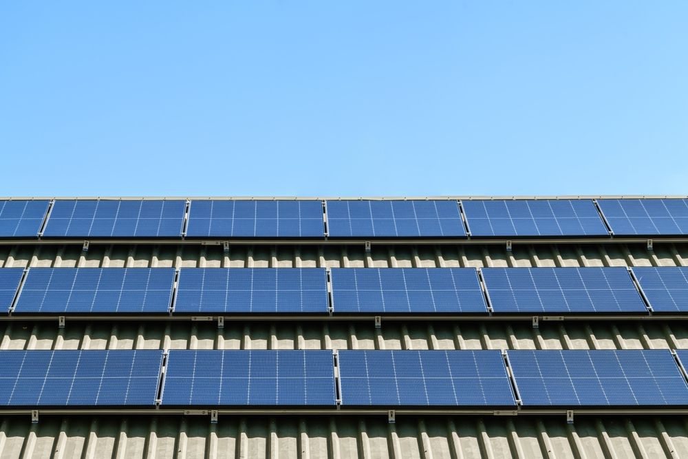 A Row of Solar Panels on the Roof of a Building Against a Blue Sky — 888 Solar Tek in Lennox Head, NSW