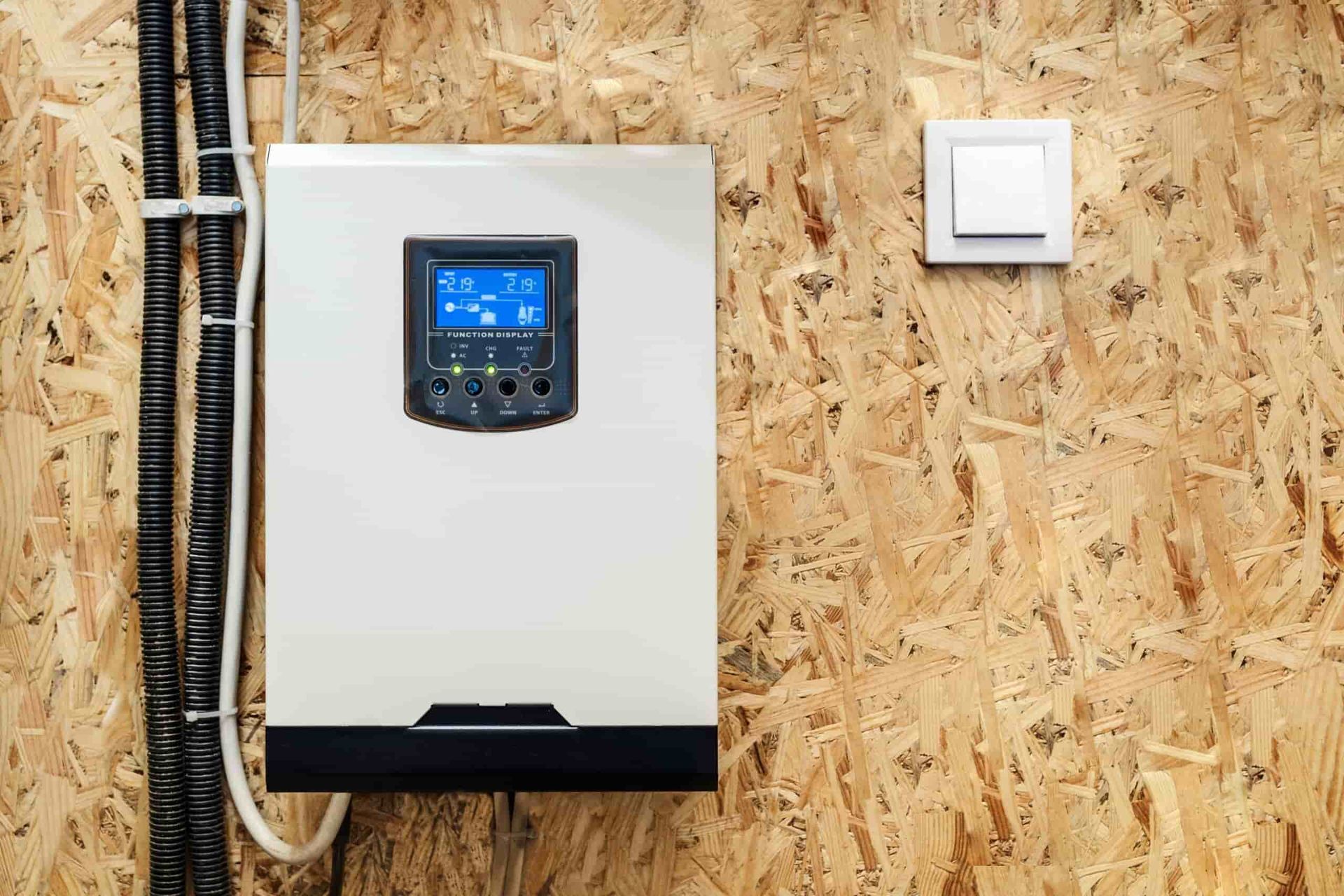 A White Box is Hanging on a Wooden Wall Next to a Light Switch — 888 Solar Tek in Tweed Heads, NSW