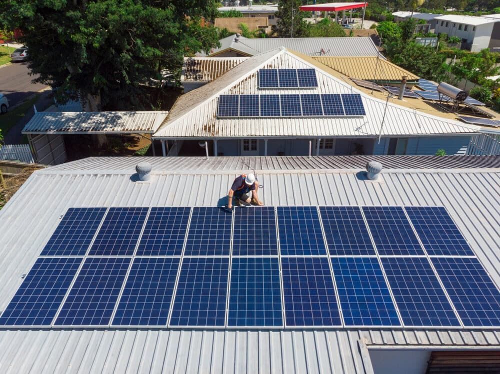 A Man is Installing Solar Panels on the Roof of a House — 888 Solar Tek in Ballina, NSW