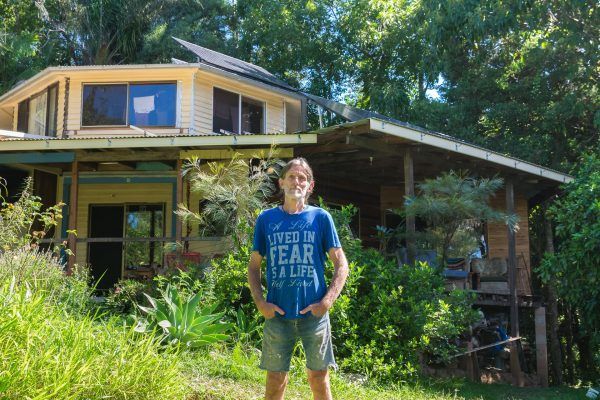 A Man in a Blue Shirt is Standing in Front of a House — 888 Solar Tek in Federal, NSW