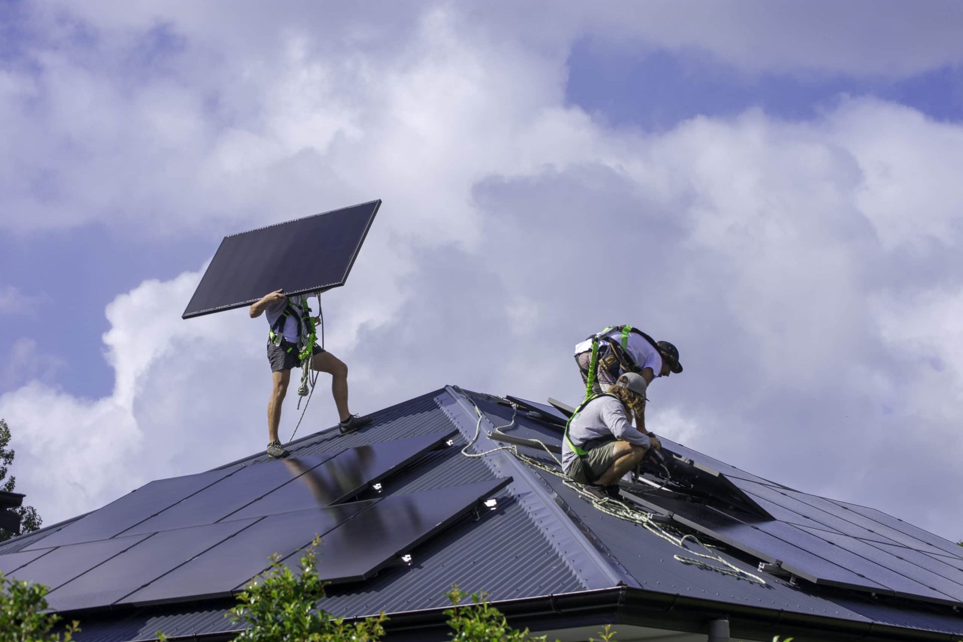 Two Men Are Installing Solar Panels on the Roof of a House — 888 Solar Tek in Federal, NSW