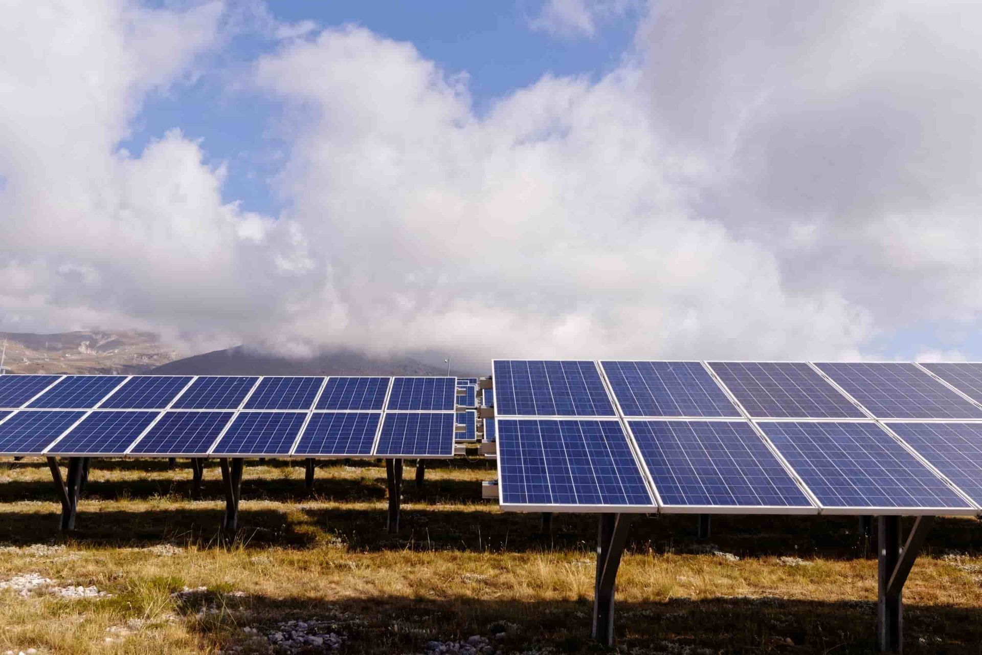 A Row of Solar Panels in a Field With a Cloudy Sky in the Background — 888 Solar Tek in Kyogle, NSW