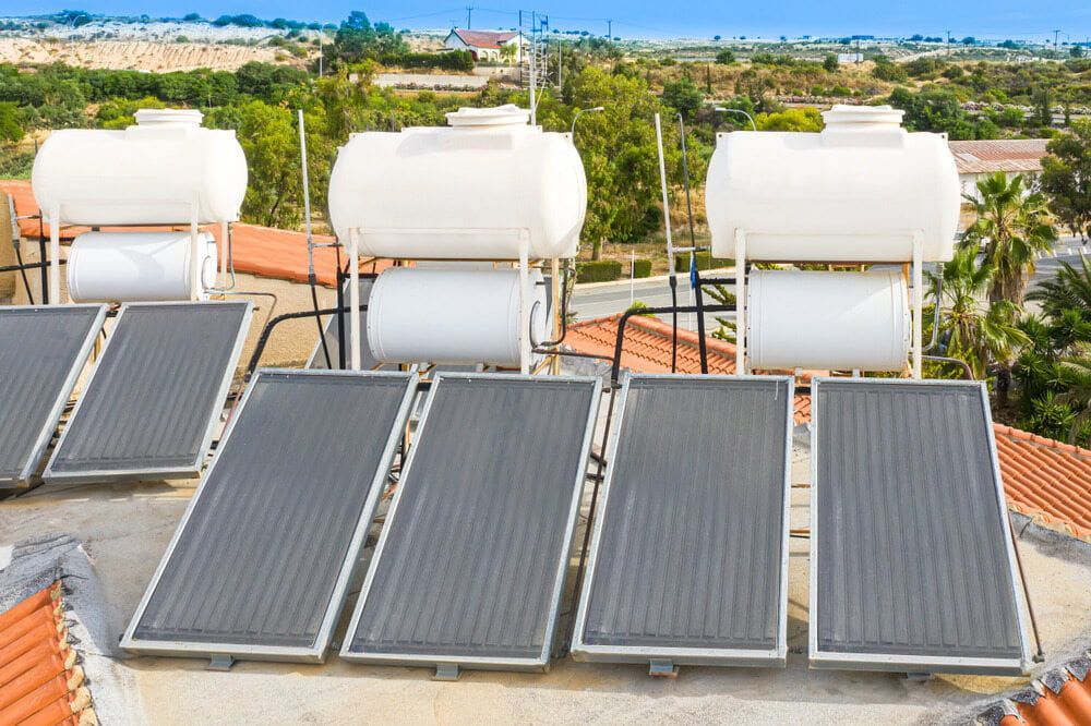 A Row of Solar Panels and Water Tanks on Top of a Roof — 888 Solar Tek in Murwillumbah, NSW