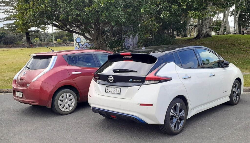 Two Electric Cars Are Parked Next to Each Other on the Side of the Road — 888 Solar Tek in Federal, NSW