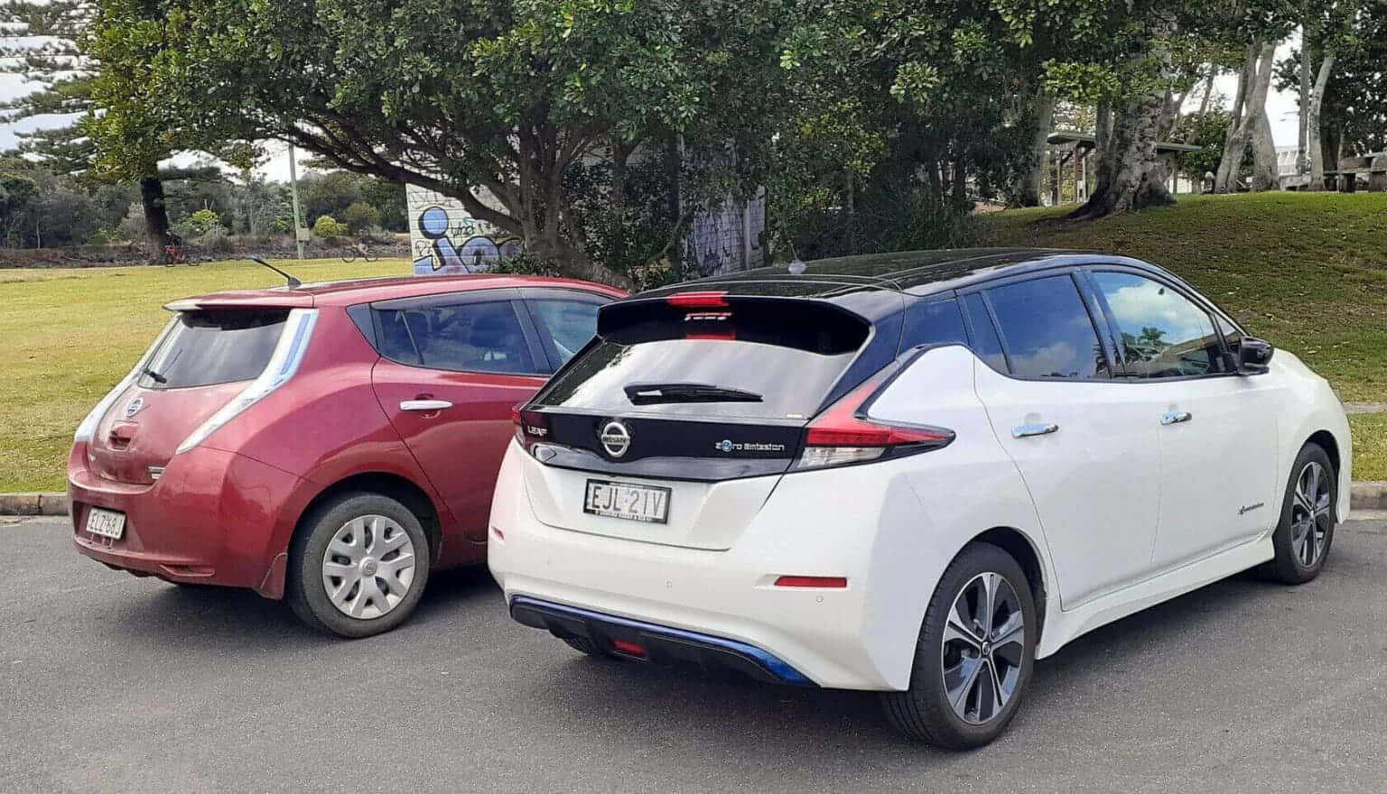 Two Electric Cars Are Parked Next to Each Other on the Side of the Road — 888 Solar Tek in Federal, NSW