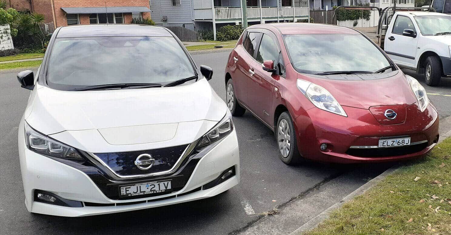 Two Electric Cars Are Parked Next to Each Other on the Side of the Road — 888 Solar Tek in Federal, NSW