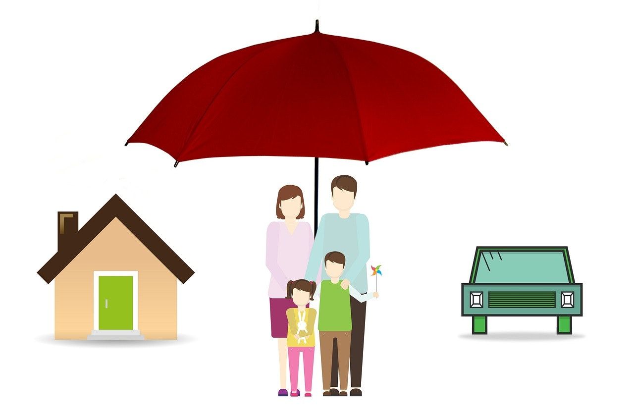 Family under red umbrella between house and car