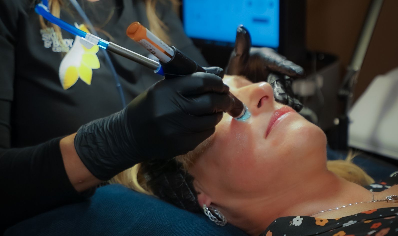 A woman is getting a facial treatment at a beauty salon.