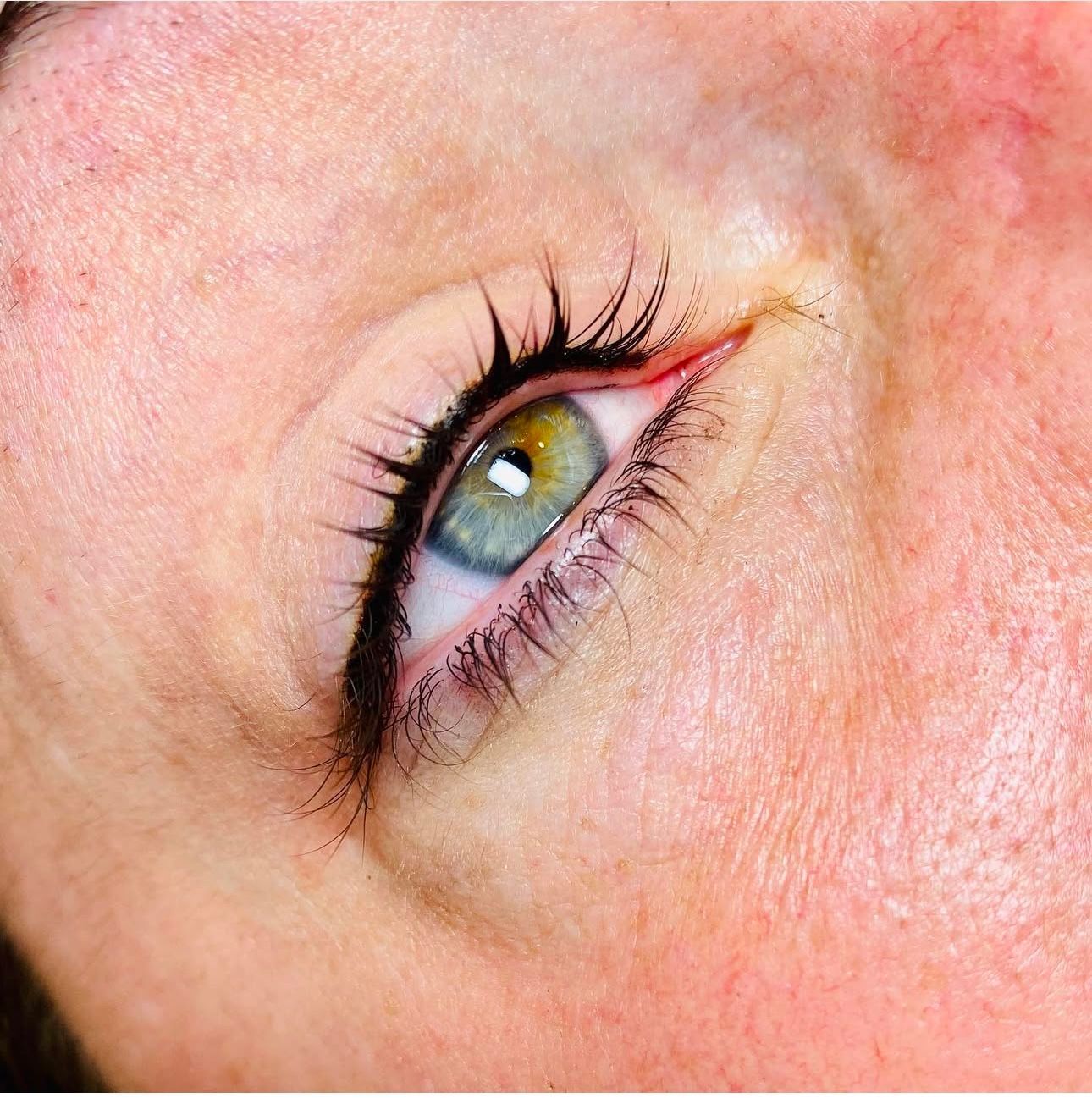 A close up of a woman 's eye with eyeliner.
