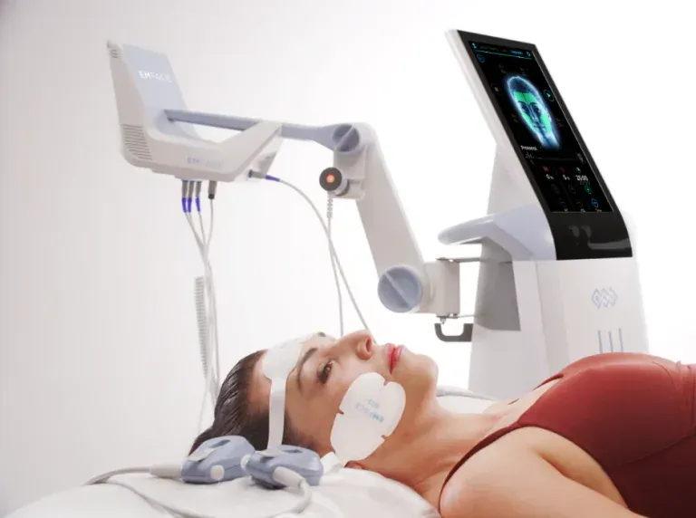 A woman is laying on a bed with a device on her head