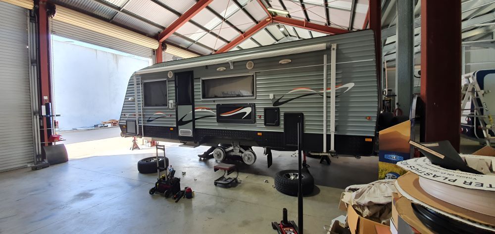 A RV is Being Repaired in a Garage — Dempsters Caravan & RV in Thabeban, QLD