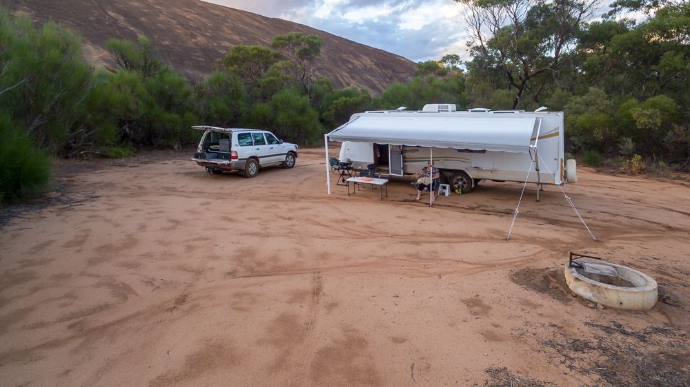 White Camper Trailer and SUV in a Sandy Desert Campsite — Dempsters Caravan & RV in Maryborough, QLD
