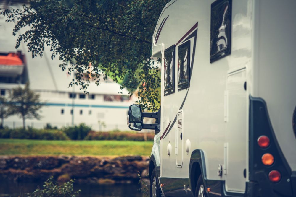 White Camper Van Parked by a Tree on a Roadside — Dempsters Caravan & RV in Childers, QLD