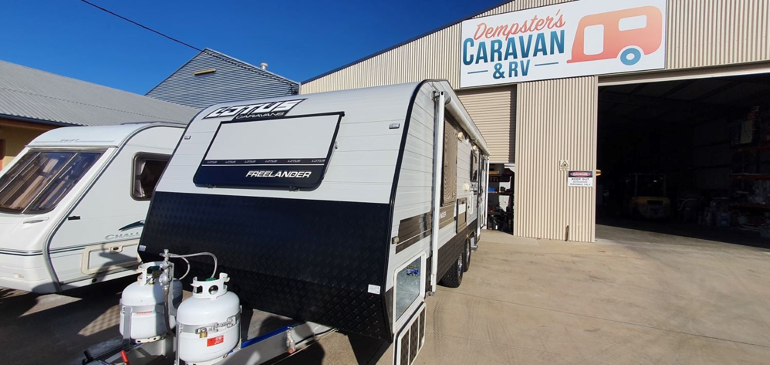 A Caravan is Parked in Front of a Building — Dempsters Caravan & RV in Thabeban, QLD