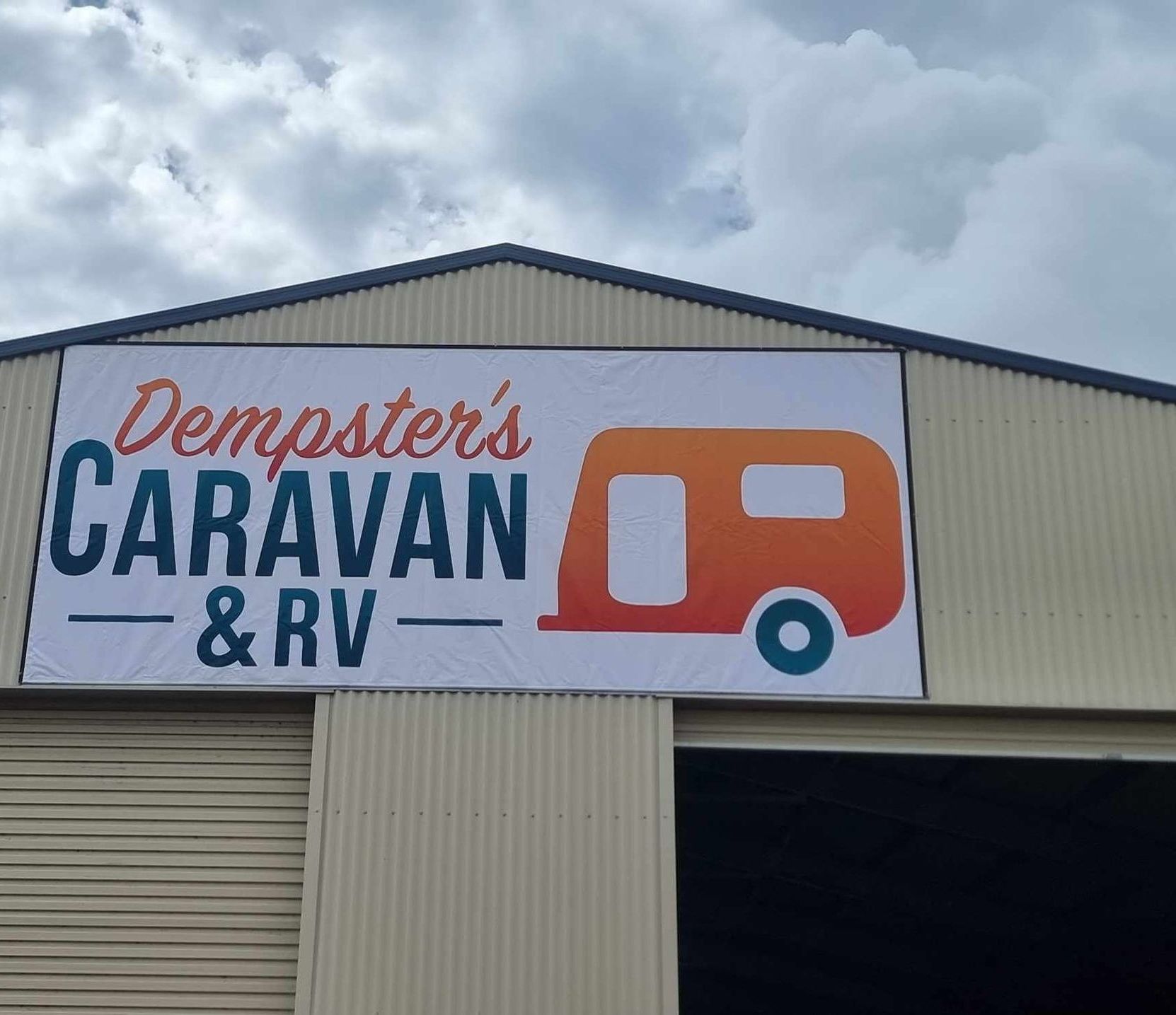 A Sign on the Side of a Building That Says Caravan and RV — Dempsters Caravan & RV in Thabeban, QLD