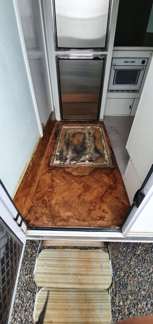 A Doorway Leading to a Kitchen With a Rug on the Floor — Dempsters Caravan & RV in Thabeban, QLD