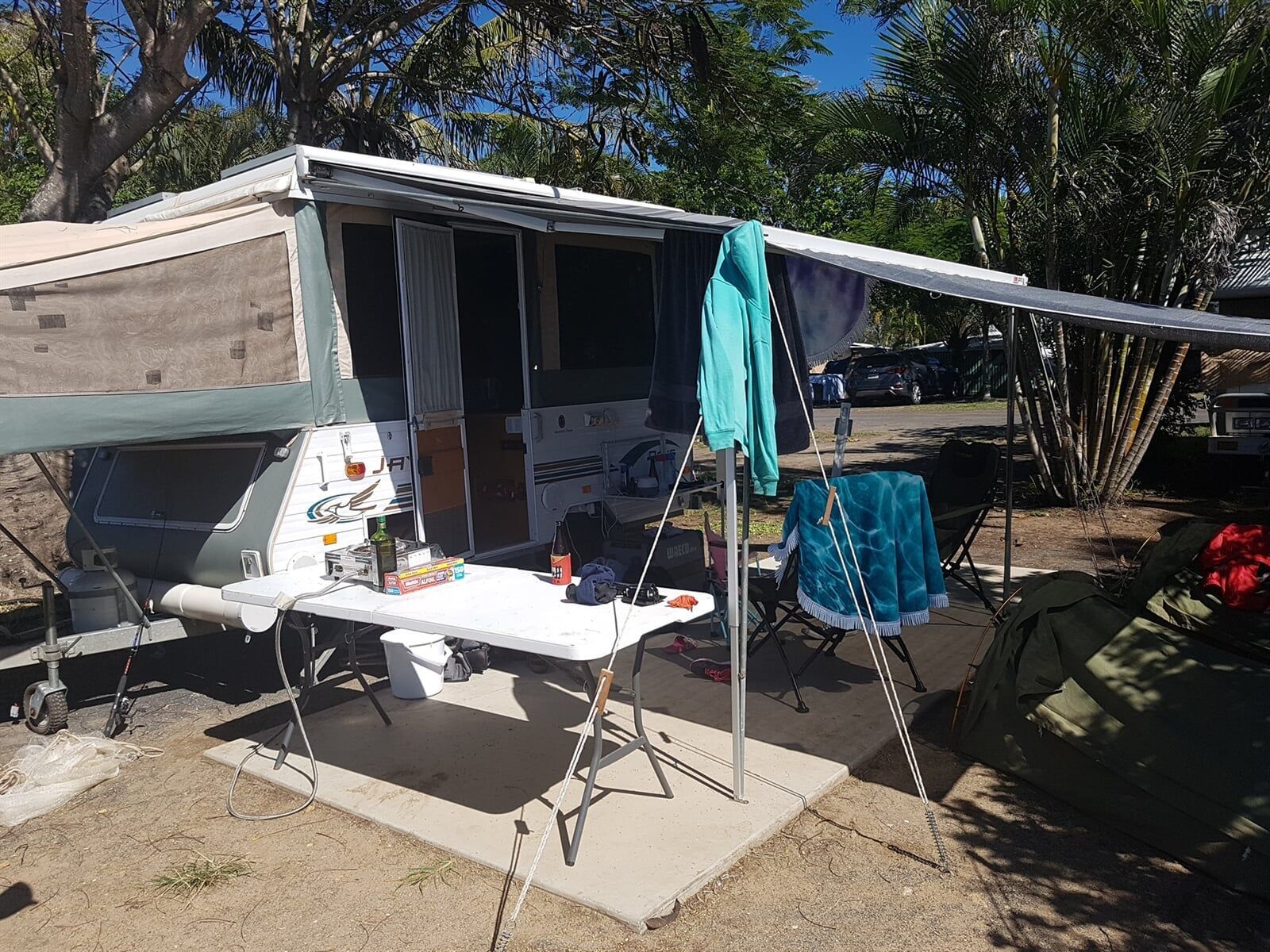 A Caravan Has an Awning and Camp Chairs Out — Dempsters Caravan & RV in Bundaberg, QLD
