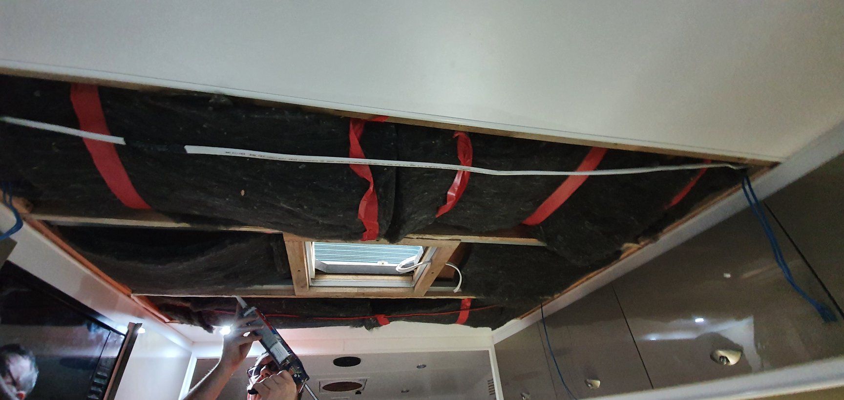 A Person is Working on the Ceiling of a Room With a Drill — Dempsters Caravan & RV in Gladstone, QLD